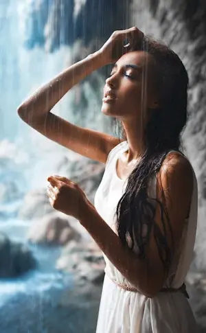 Alina Astrovskaya under a waterfall