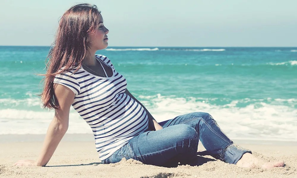 Beautiful pregnant woman on the sea