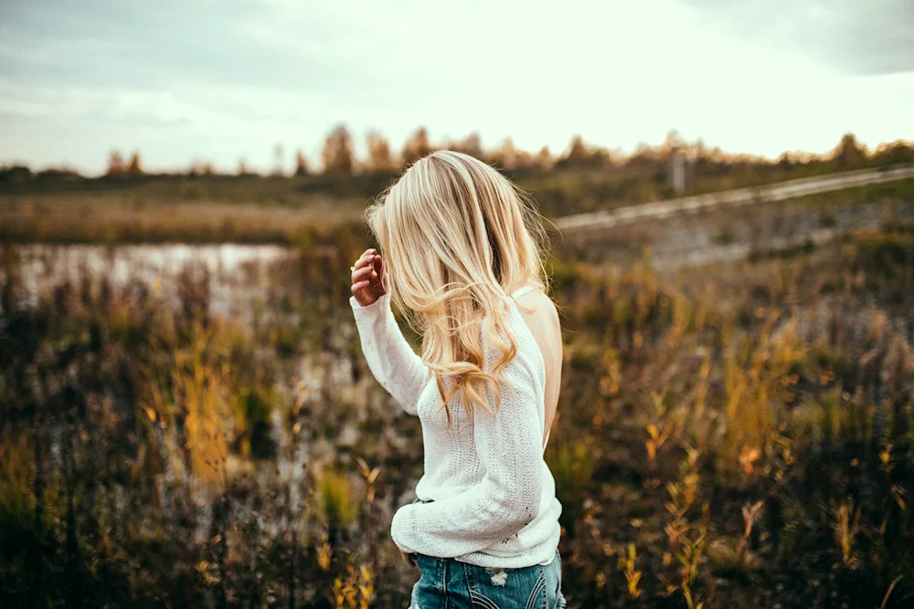 Sad blonde girl with back