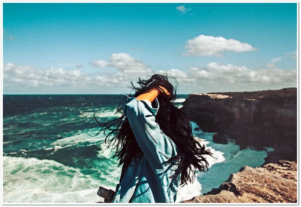 Brunette girl at sea from back