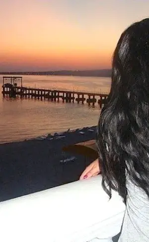 Brunette with long hair at the sea