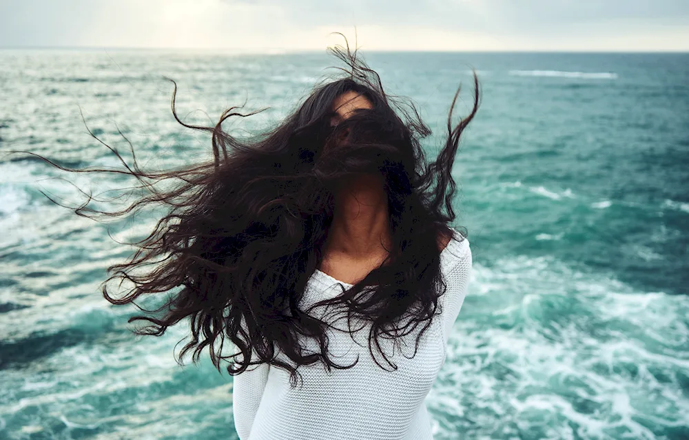 Girl with back in nature sea