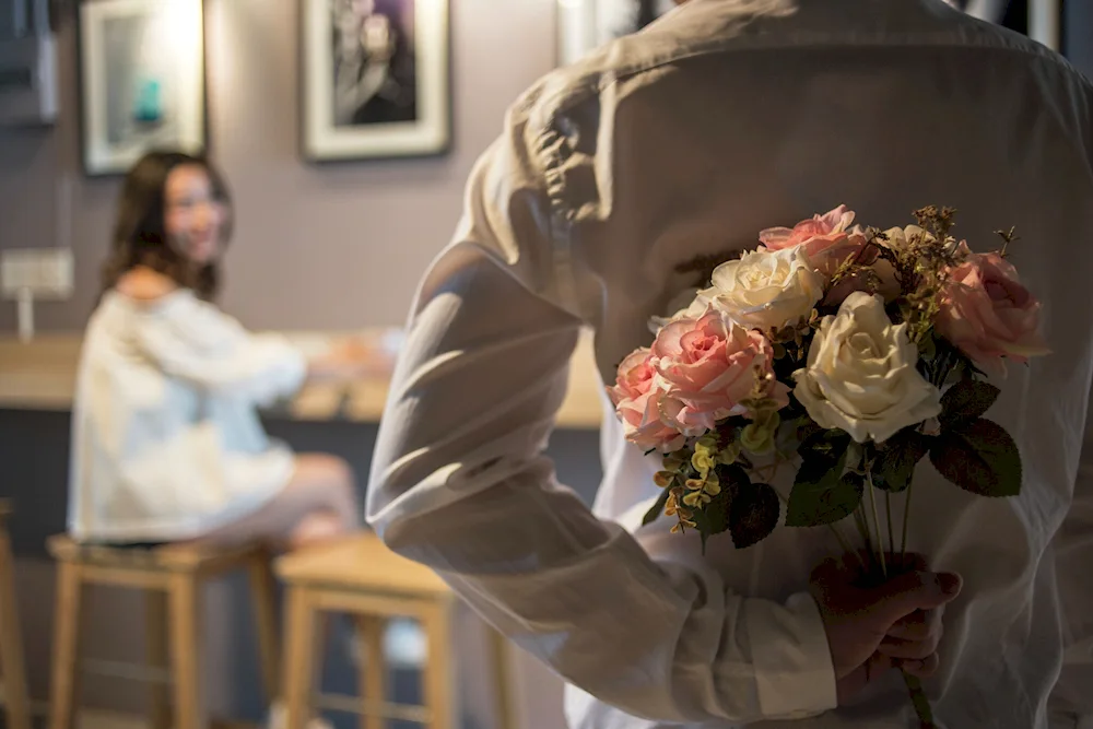 Guy giving flowers to a girl