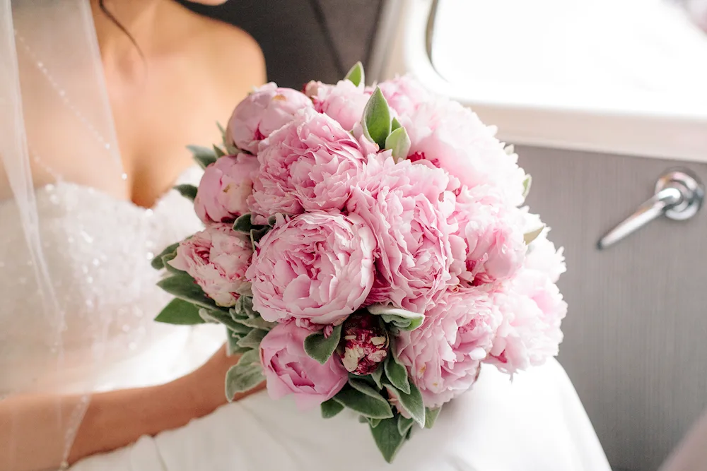 Bouquet of flowers in the car with peonies