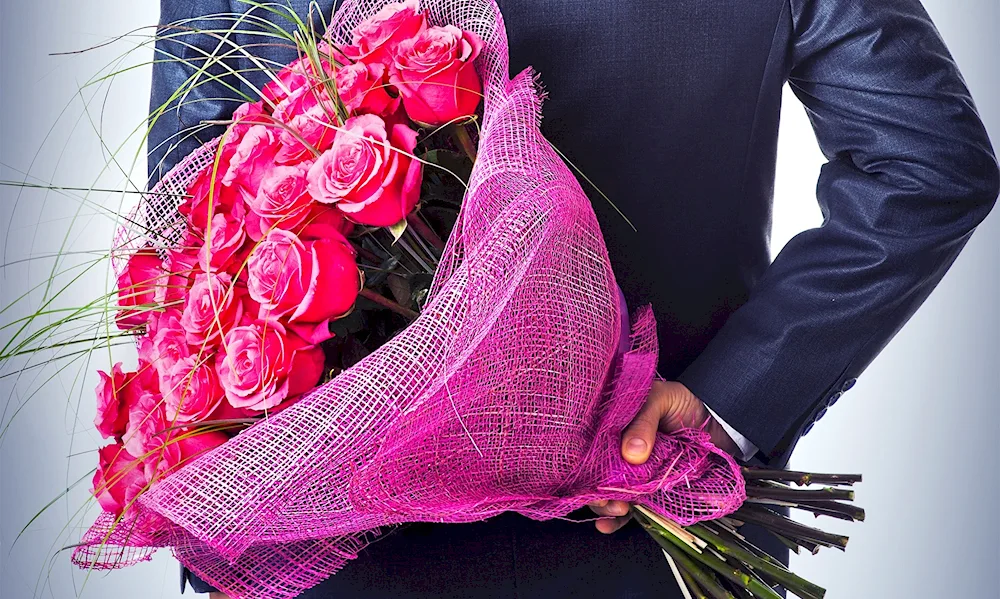 Bouquet of flowers in the hands of a man