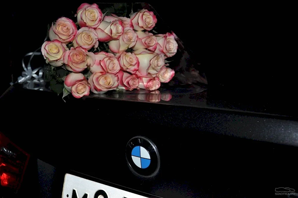 A bunch of flowers on the bonnet of the car