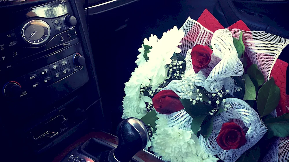 Girl with flowers in the car