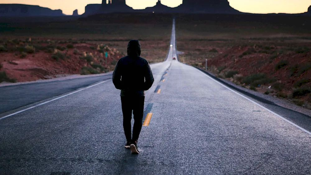 The man walking along the road