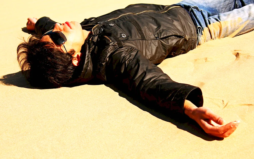 A man lying in the sand