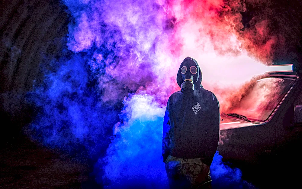 A man in a gas mask in the smoke