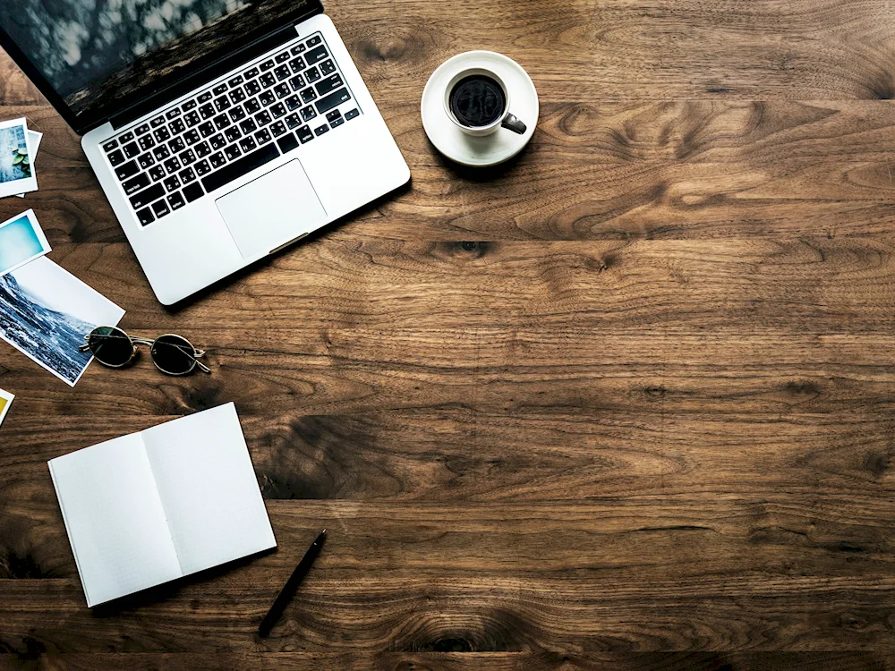 Wooden background desk with laptop