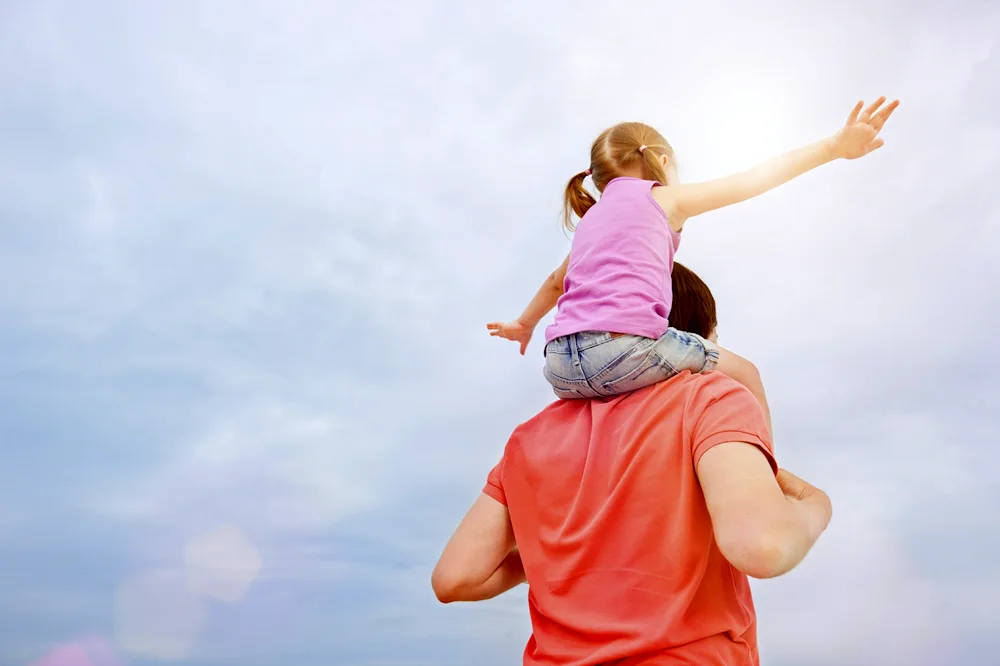 Daughter on daddy's neck
