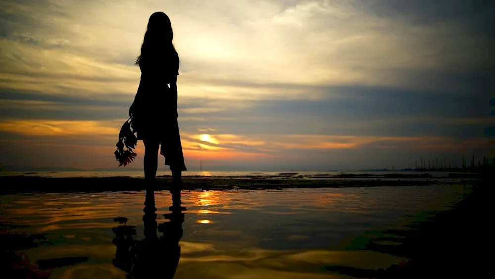 Girl on the beach with her back