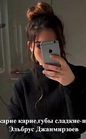 Girl with iPhone in the mirror