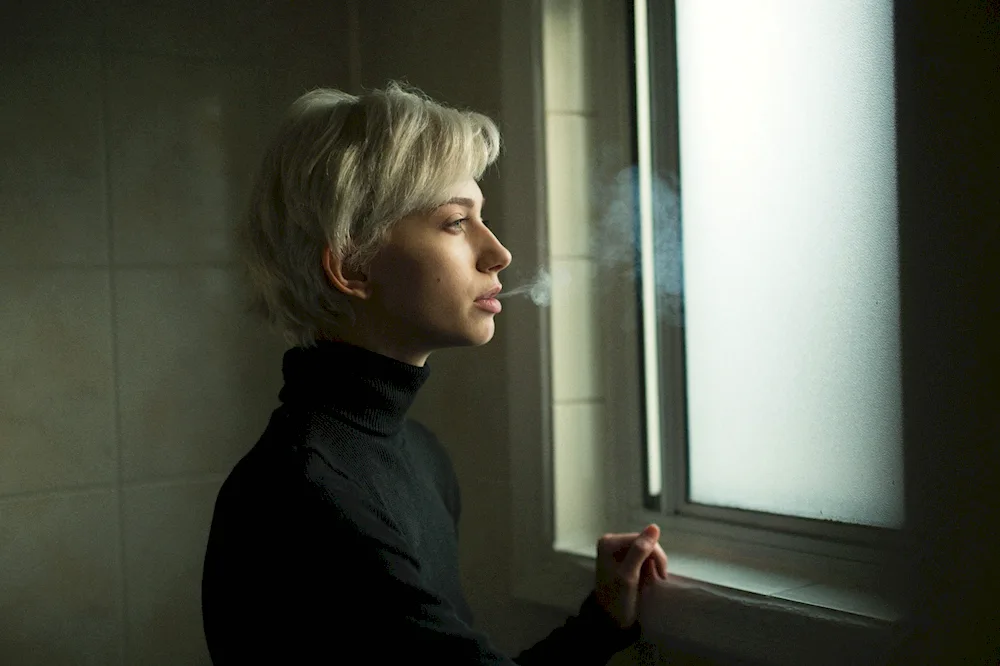 Girl with short haircut smokes