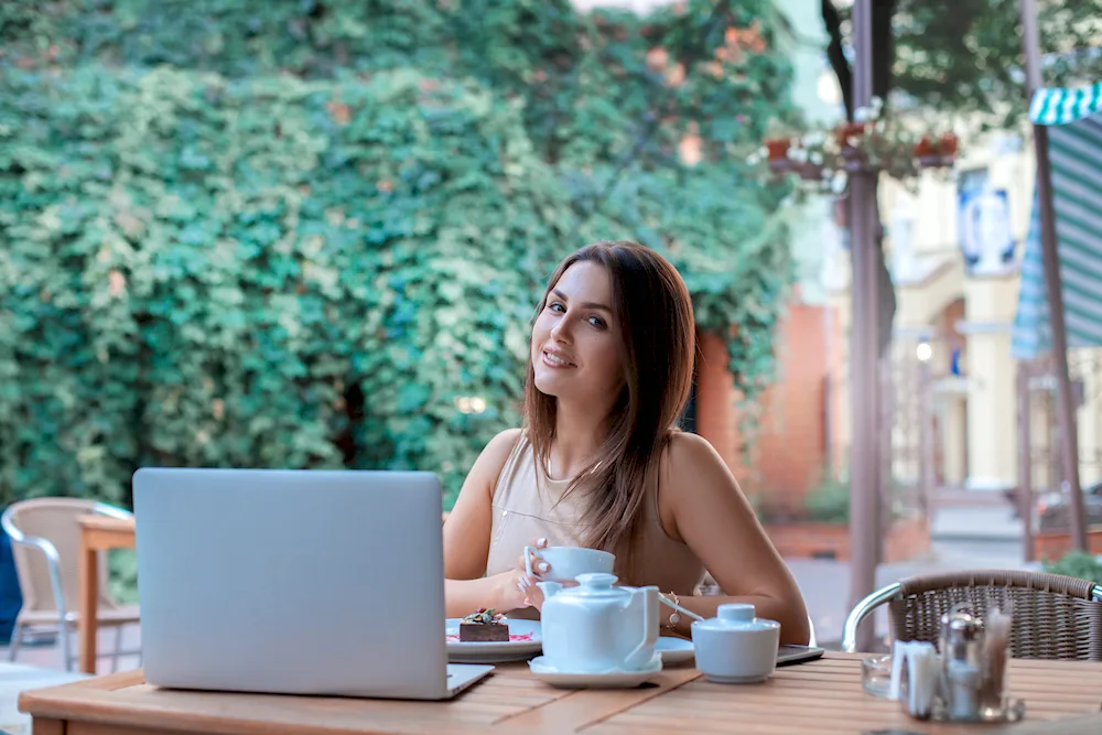 Girl with laptop in cafe