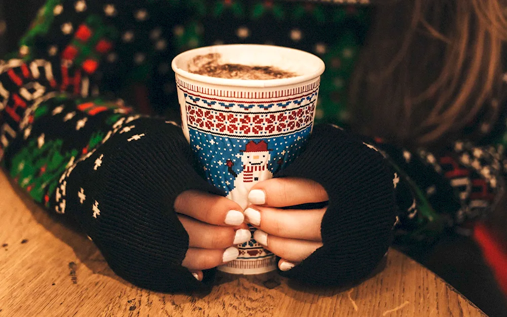 Girl in jumper with cup