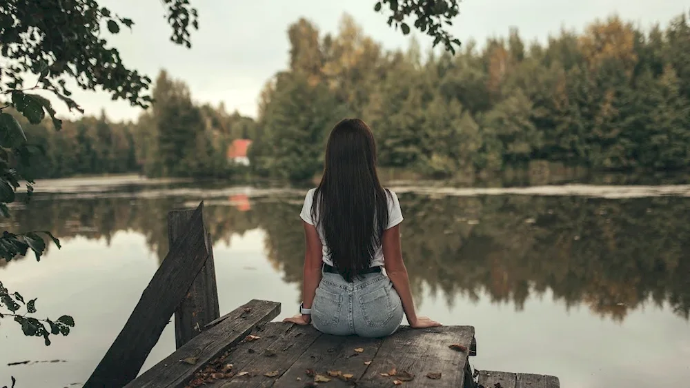 Brunette at sea from back