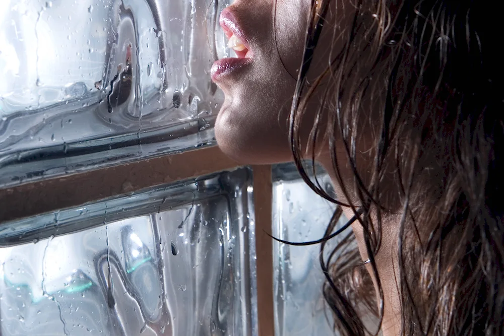 Girl behind the wet glass