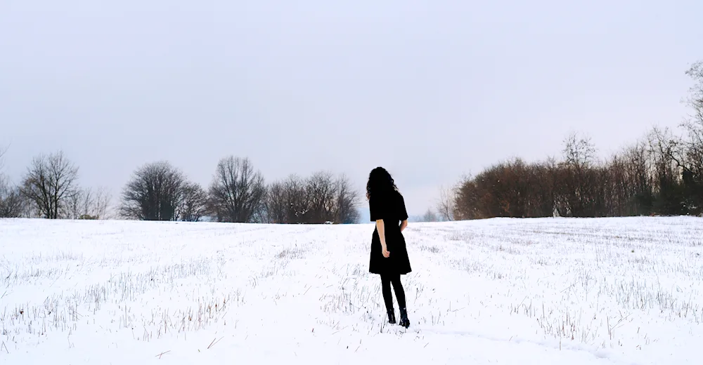 Winter girl in the forest with back