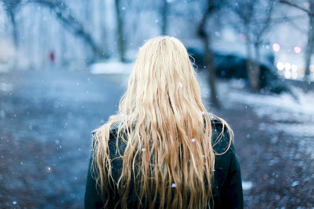 Blonde in the mountains from the back
