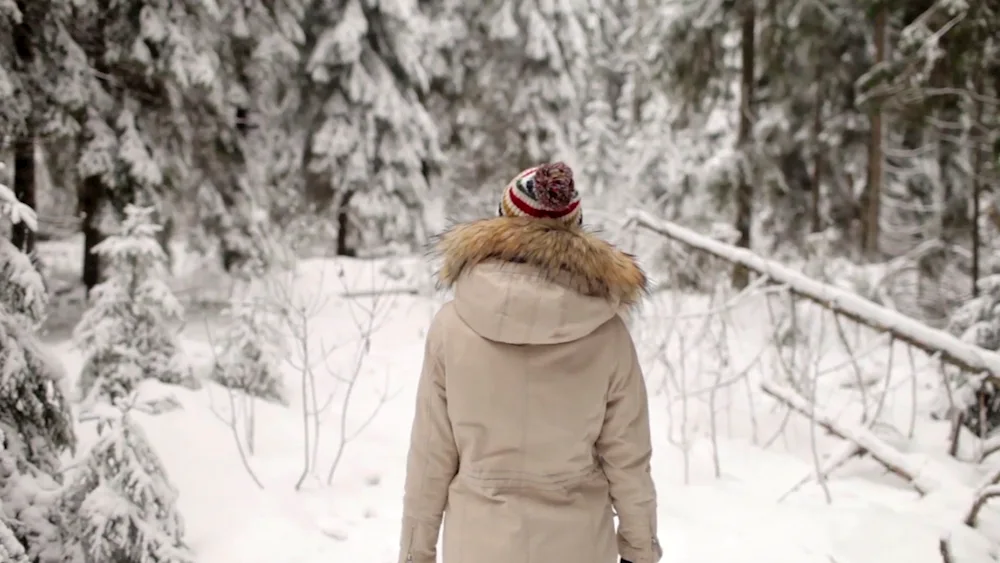 Winter girl in the forest with back