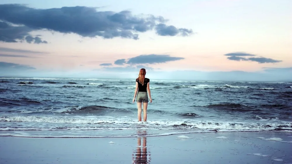 Girl with long hair by the sea