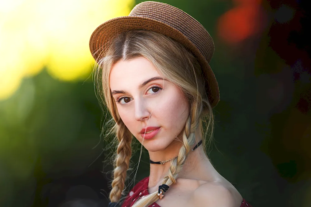 Girls in a hat with pigtails