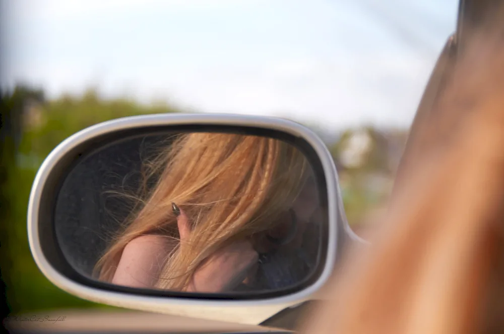 Photo in the car mirror girl