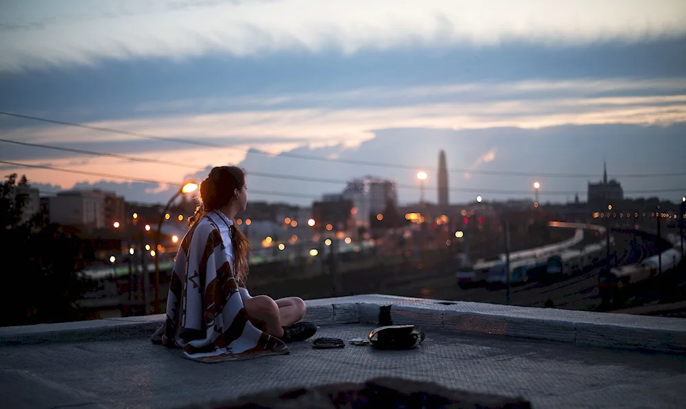 Girl on the roof in the night city