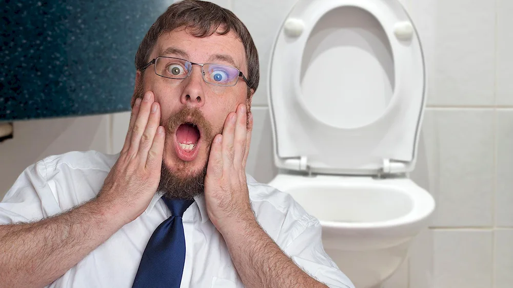 A frightened guy in a toilet