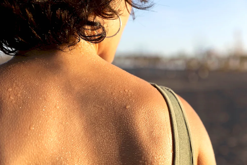 Sweat drops running down her skin