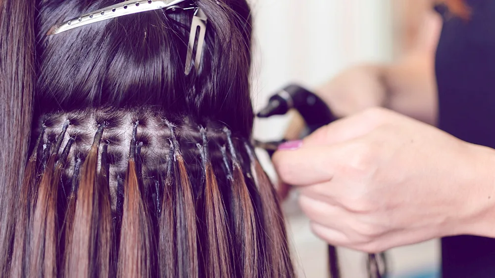 False coloured hair strands on hairpins