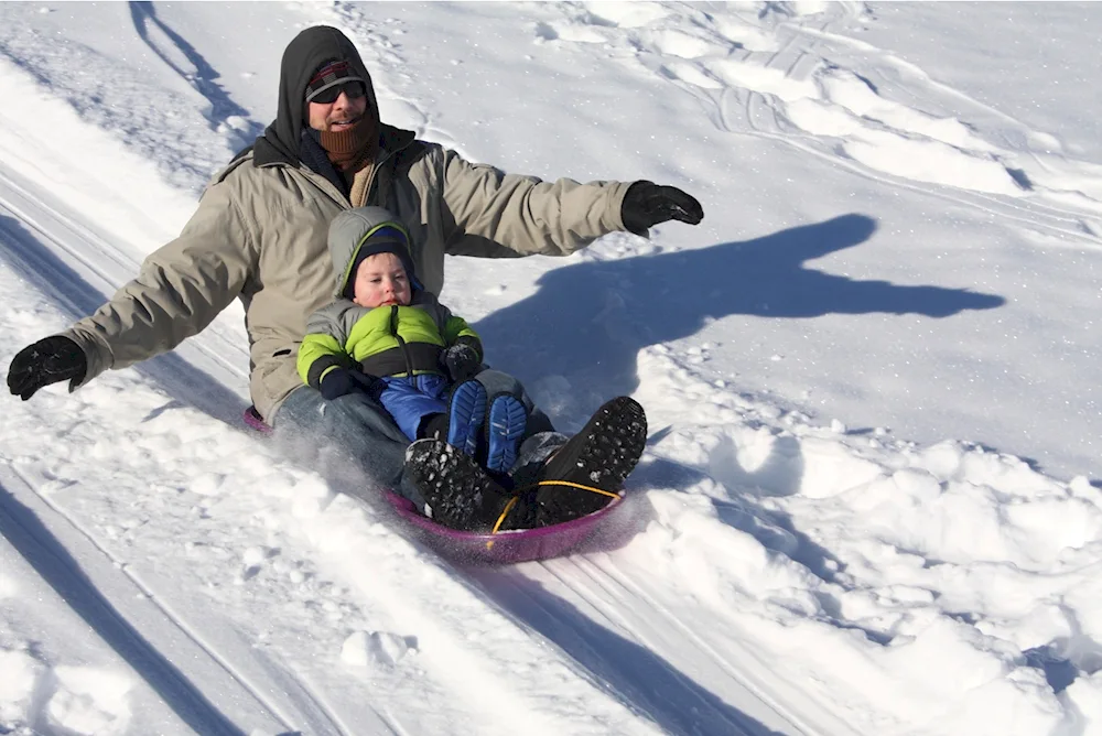 Children sledding down the hill