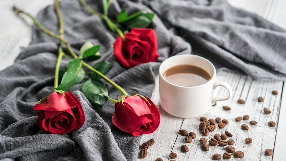 A cup of coffee and a rose