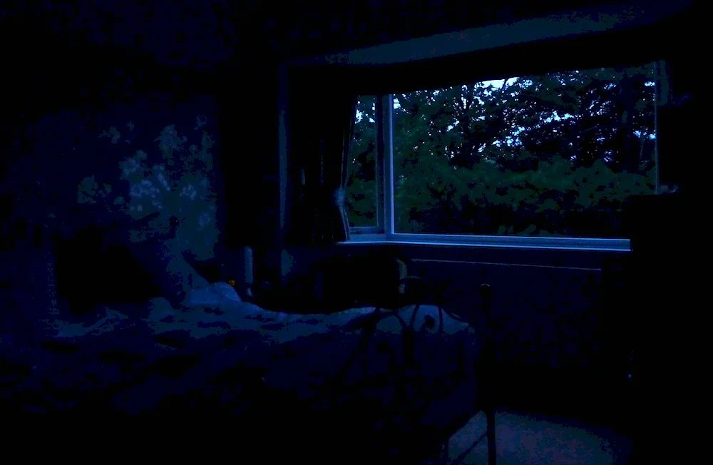 Dark room with bed in the dark