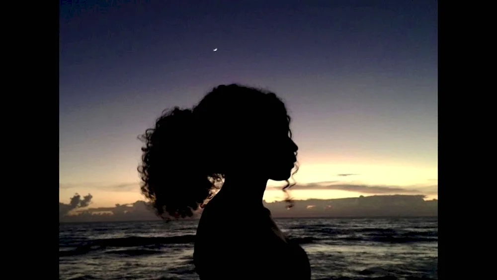 Curly girl at sunset