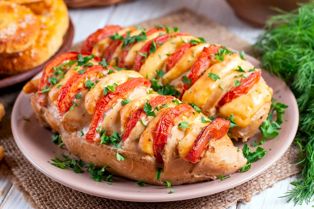 Chicken fillet accordion with tomatoes and cheese in the oven