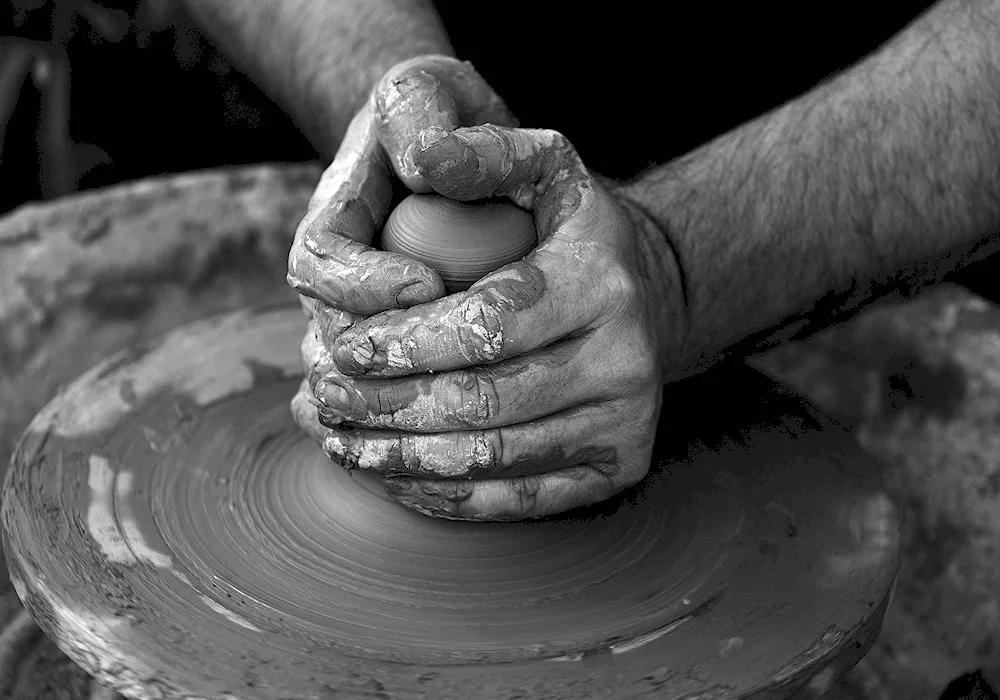 Moulding clay on the potter's wheel