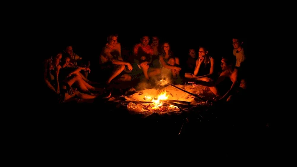 Sitting around the campfire with a guitar