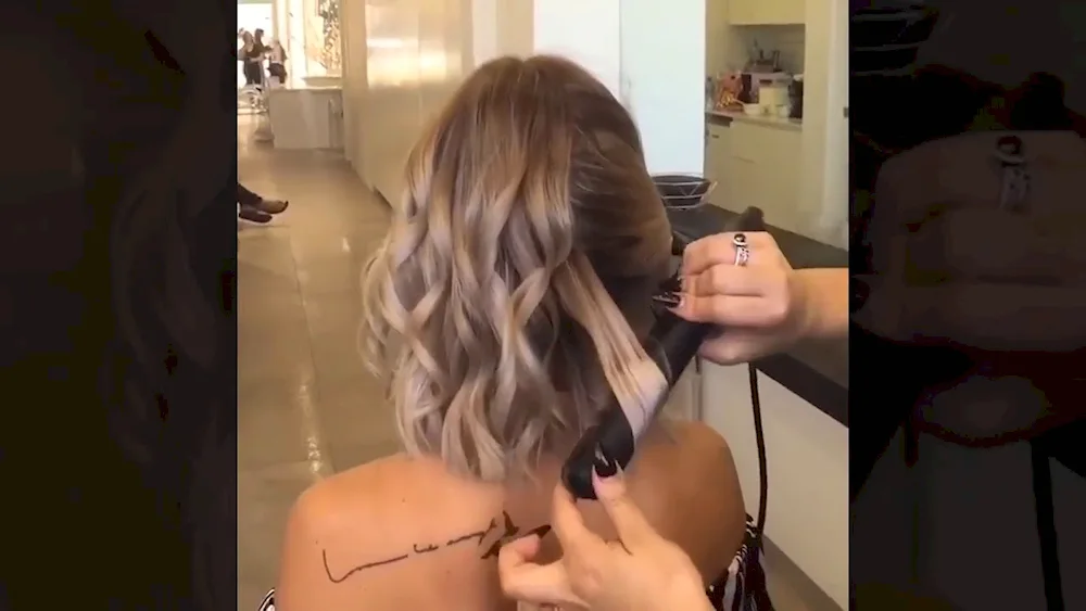 Middle hair curls with fringes with a curling iron