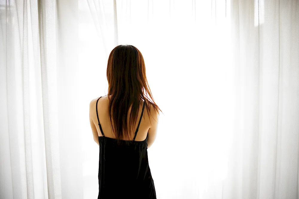 Girl hangs curtains