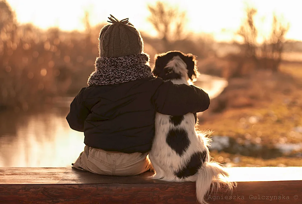 Boy hugging dog