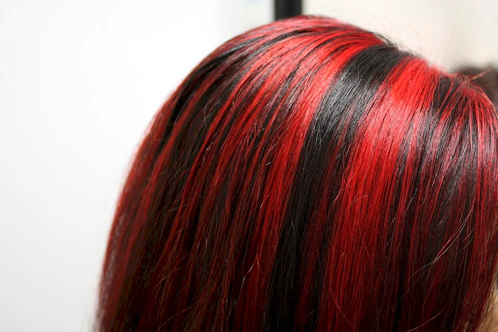 Burgundy shading on dark hair with red strands