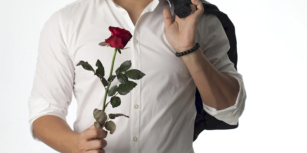 A man in a suit with a bouquet