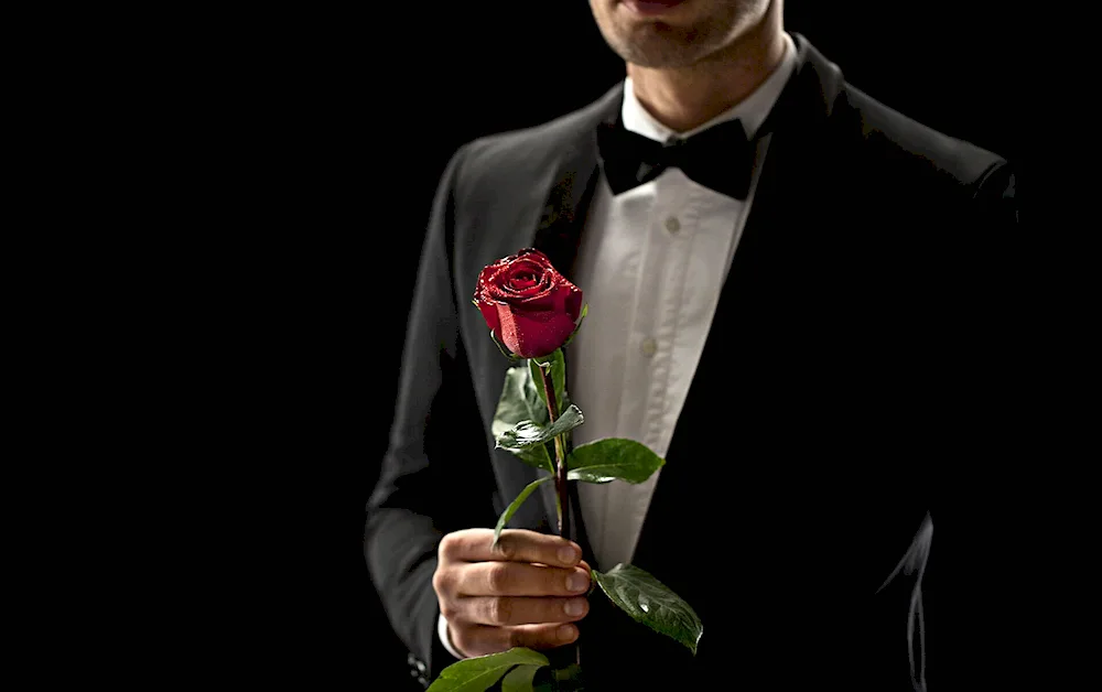 A man in a suit with a bouquet