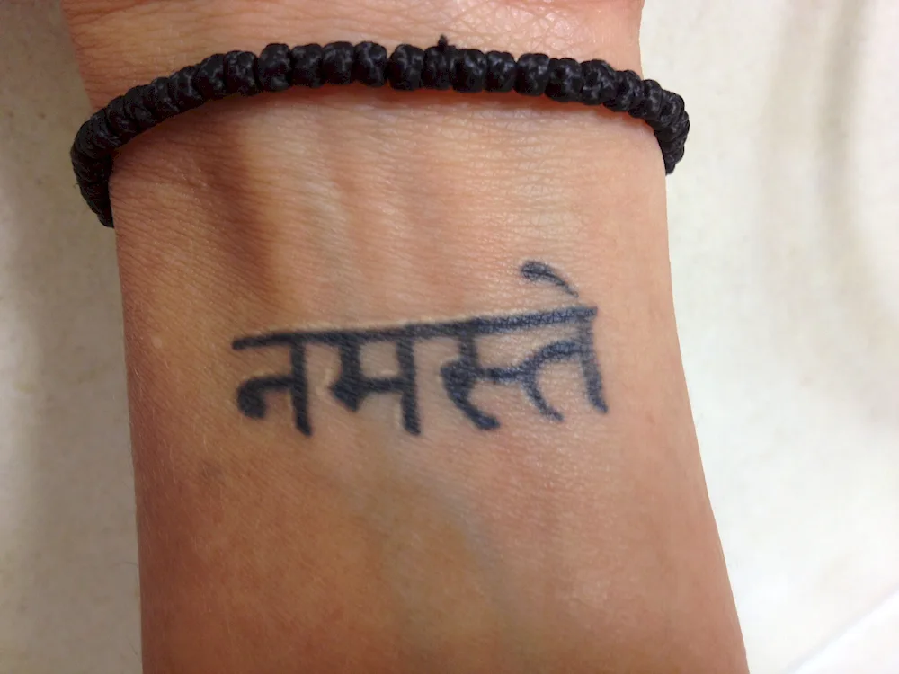 Namaste wrist tattoo in Sanskrit