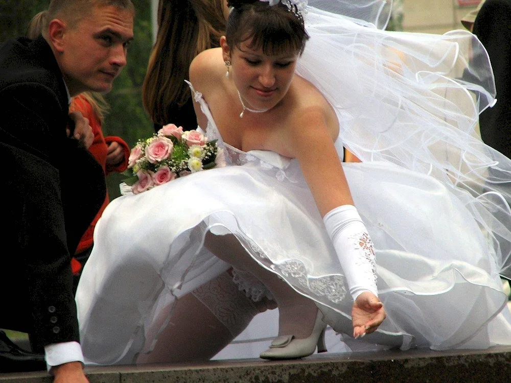 The bride in wedding dresses under the dress