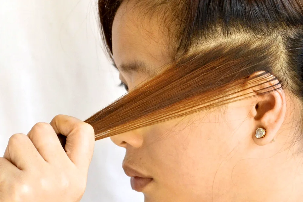 Lightened strands at the ears