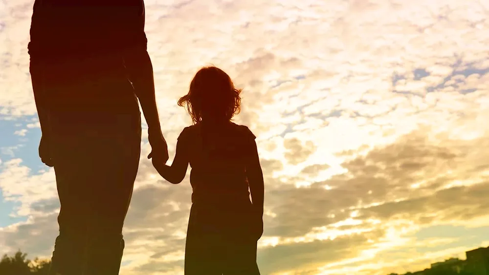Dad and daughter at sunset